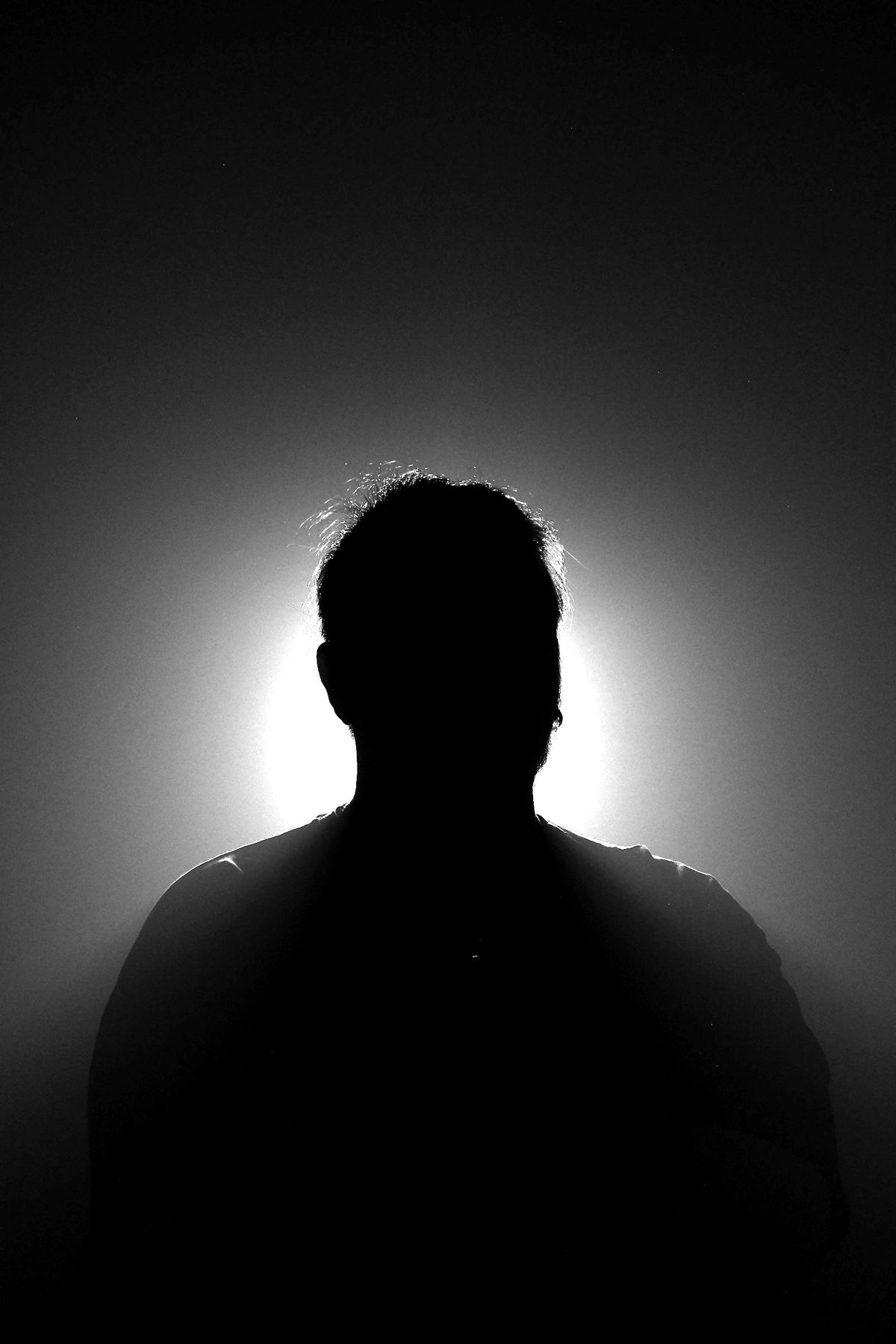 A figure backlit against a halo of light