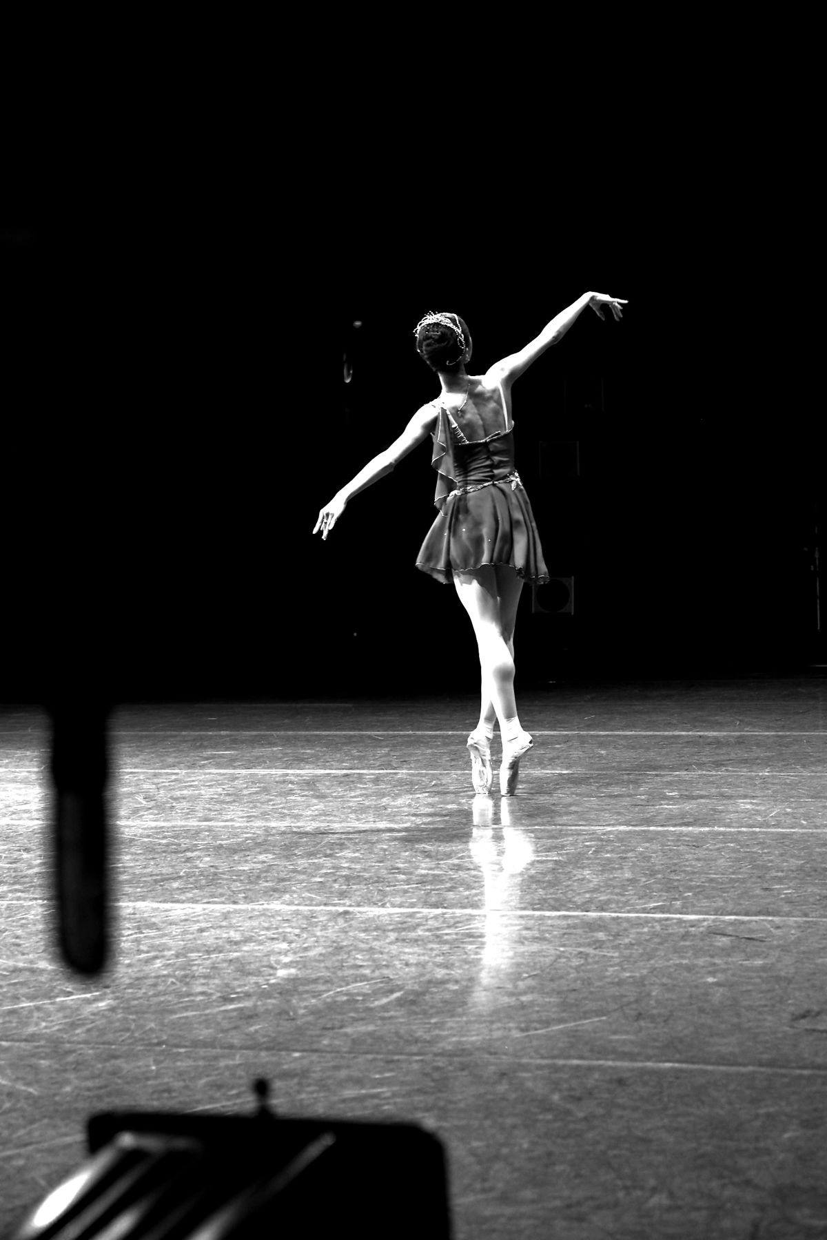 A dancer alone under a single spotlight